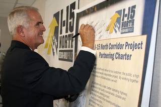 Gov. Jim Gibbons adds his signature to the I-15 North Design-Build Project's charter following a press conference in North Las Vegas on July 24, 2008 