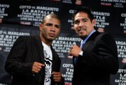 Miguel Cotto, of Puerto Rico, left, and Antonio Margarito, of Mexico, right, pose after a news conference to promote their July 26 world welterweight championship boxing match Thursday, May 22, 2008 in New York.