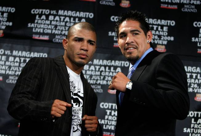 Miguel Cotto, of Puerto Rico, left, and Antonio Margarito, of Mexico, right, pose after a news conference to promote their July 26 world welterweight championship boxing match Thursday, May 22, 2008 in New York.