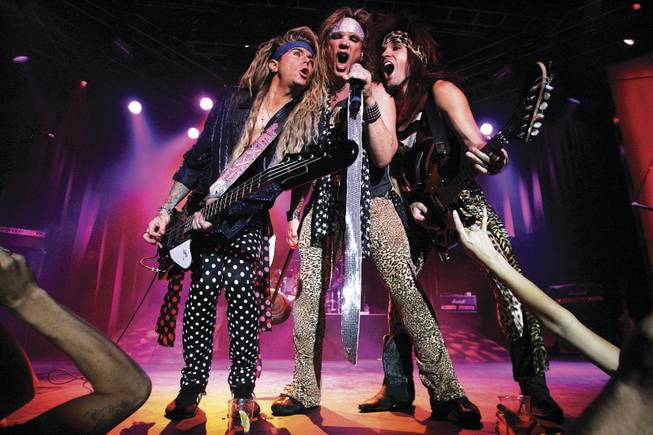 Steel Panther is composed of, from left, bass player Lexxi Foxxx, singer Michael Starr, guitarist Satchel and, not shown, drummer Stix. 
