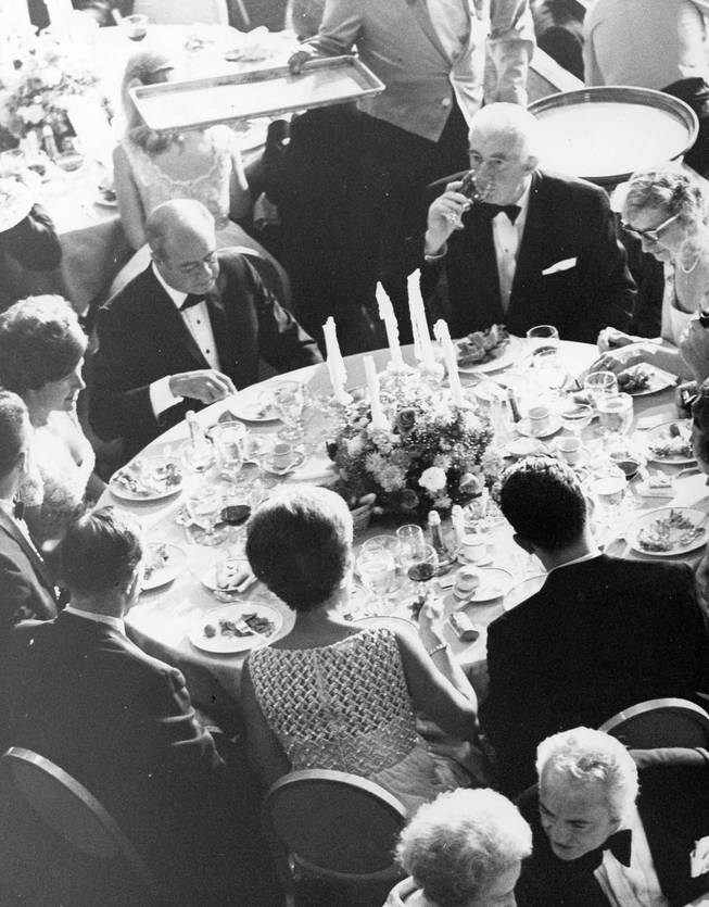 Bob Maheu (on the left, looking down), and his wife, Yvette, dine at Caesars Palace in this 1969 photo. 