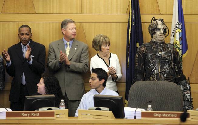 Commissioners, from left, Lawrence Weekly, Chip Maxfield and Susan Brager applaud as 3 of 6, a character from "Star Trek: The Experience," is introduced at the Clark County Commission meeting Tuesday. Star Trek was honored for its 10-year run at the Hilton.