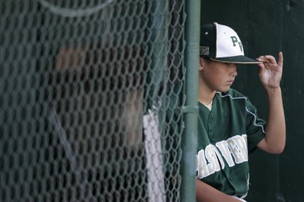 Paseo Verde All-Stars' Stevie Farmer puts on his cap as they prepare to play Waipio, Hawaii, in the western regional championship game of the Little League World Series Sunday.