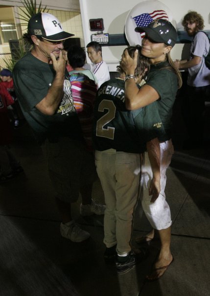 Mark and Julie Grenier comfort their son, Paseo Verde All-Stars third baseman Cadyn Grenier, after their team lost to the team from Waipio, Hawaii 4-3 in the western regional championship game of the Little League World Series Sunday.