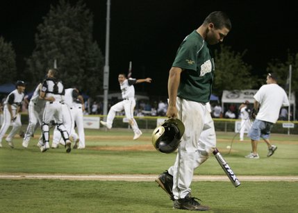 Paseo Verde All-Stars pitcher Michael Blasko walks off the field after the final out as the team from Waipio, Hawaii celebrates its 4-3 win in the western regional championship game of the Little League World Series Sunday.