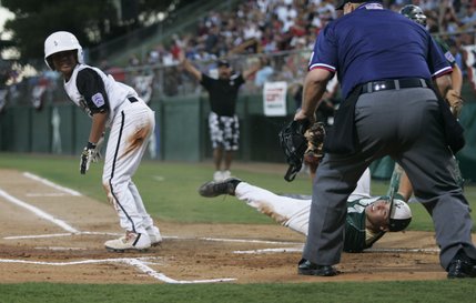 Paseo Verde All-Stars pitcher Michael Blasko looks for the call from plate umpire John Halloran as Waipio, Hawaii's Boy Donahue slides in for a run on a passed ball in the western regional championship game of the Little League World Series Sunday.