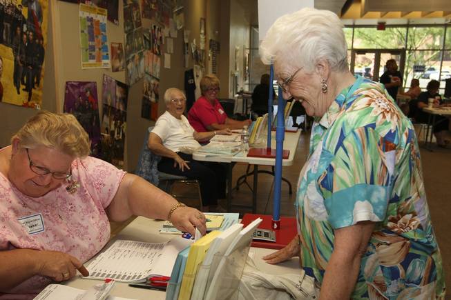 Clark County election clerk Patricia Wagner, left, checks the voter registration list as Beatrice Watson arrives to cast her votes in the primary election at Shadow Hills Baptist Church. When asked her party affiliation, Watson proudly said, "I was Democrat the day I was born 'til the day I die."