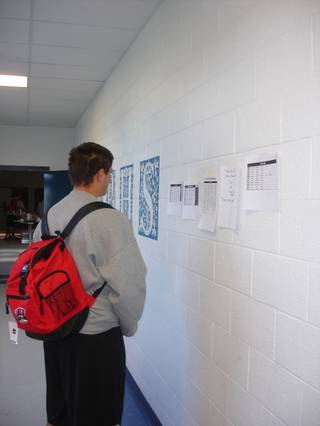Sophomore tight end Kyle Watkins checks out the day's rundown posted in the main entrance at White Pine High early Tuesday morning in Ely.