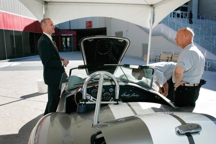 
Johnnie Stoker, left, president and chief executive of Henderson-based K2 Energy Solutions, shows off an electric HST Shelby Cobra to Kelvin Woods and Joseph Born at the National Clean Energy Summit on Tuesday. The car is equipped with lithium iron phosphate batteries and can travel from 0 to 60 mph in 3.5 seconds, Stoker said.
