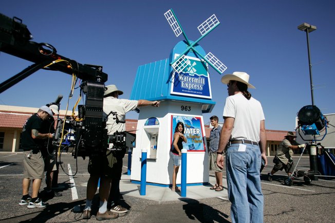 Stand-ins Lisa Caragol and Hunter Doerwald, center, help crew members for the television show "Easy Money" work on composition and lighting last week on the set in an old Albuquerque strip mall. 