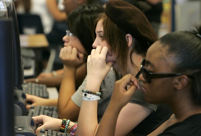 Students take a reading placement test in the library during a freshman orientation at Cheyenne High School. Teens say they worry about social pressures, career choices and economic issues.