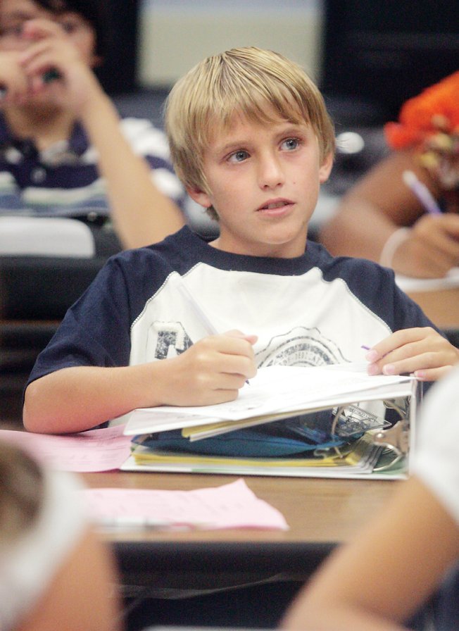 Max Larnerd takes notes on the first day of classes at Bob Miller Middle School. Larnerd starts his sixth-grade career as the son of the principal.  