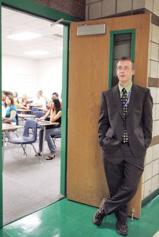 Josh Adams waits at his classroom door for straggling students on the first day of classes at Green Valley High School on Monday. Adams, a new math teacher, recently moved to Las Vegas from Kansas.
