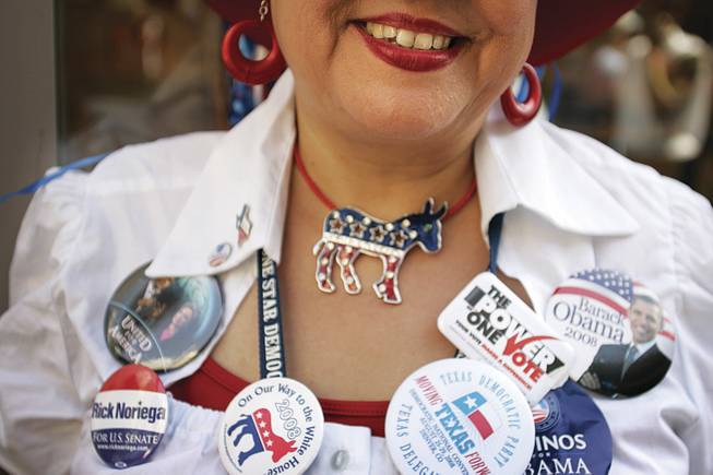 Conventiongoer Lucy Rubio of Corpus Christi, Texas, is adorned with political buttons and bling galore.