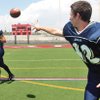 Boulder City High quarterback Jake Phillips, right, had a busy offseason learning the Eagles' new spread option offense under first-year coach Alex Kazel. He pitches the ball to Alex Critcher.