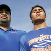 Bishop Gorman assistant football coach Lonnie Palelei, left, stands with son Evan, a junior linebacker for the Gaels. Lonnie Palelei, who played eight years in the NFL, has helped coach at Gorman since 2002.