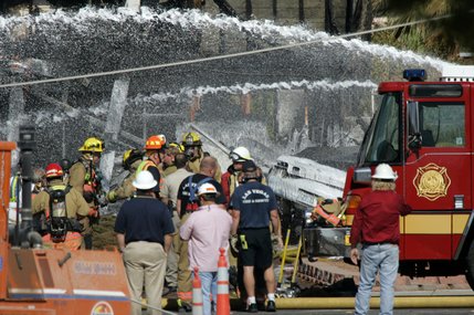 Firefighters work on putting out hot spots after a twin-engine Piper Navajo crashed into a home on North Jones Boulevard near Cheyenne Avenue Thursday, Aug. 28, 2008.  


