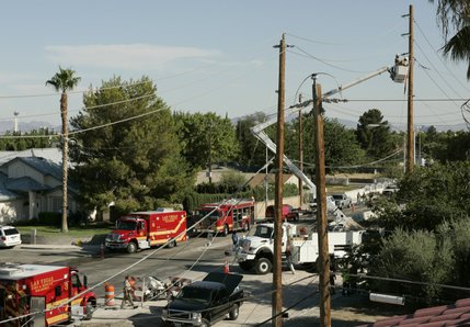A crew from Nevada Power works to restore power on North Jones Boulevard near Cheyenne Avenue after a twin-engine Piper Navajo clipped the power lines, then crashed into a home Thursday, Aug. 28, 2008.  