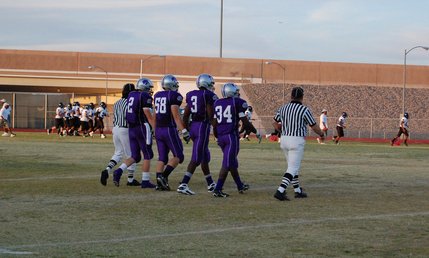 Senior captains Michael Wadsworth, Darren Dehart, Keenan Graham and Terran Madu-Jules walk to the center of the field for the coin toss. 