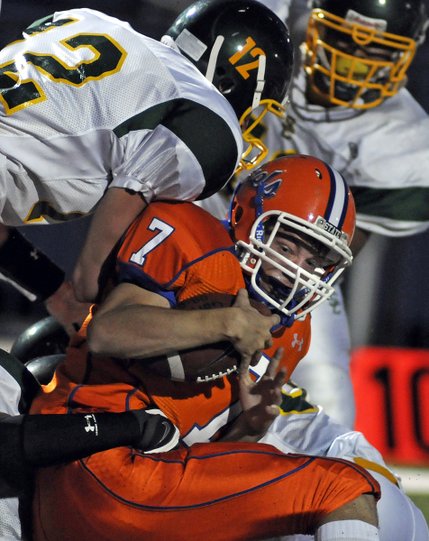 Bishop Gorman's John Therrell battles toward the goal line but is stopped by several Service tacklers during the Gaels' home opener at Fertitta Field on Friday.