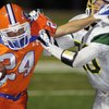 Bishop Gorman receiver No. 24 Robert Hassler fights off the tackle of Service High's No. 80 Matthew Weedman after a second-half reception during the Gaels' home opener at Fertitta Field on Friday.