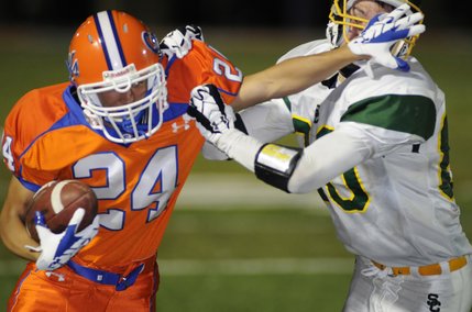 Bishop Gorman receiver No. 24 Robert Hassler fights off the tackle of Service High's No. 80 Matthew Weedman after a second-half reception during the Gaels' home opener at Fertitta Field on Friday.