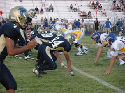Ready to charge, the Foothill Falcons face the Fountain Valley Barons while waiting for the snap.