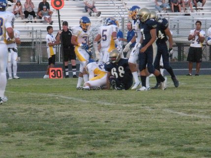 No. 8 Aaron Dupin ends up at the bottom of the tackle pile during a play in the first quarter of Friday's game.