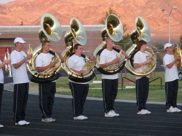 The Falcons' tuba section greets the team as it rushes ...