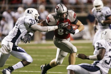 Utah State safety Caleb Taylor tries to stop UNLV wide receiver Ryan Wolfe during the second quarter Saturday at Sam Boyd Stadium.