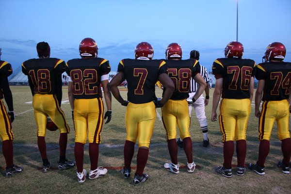 Members of the Del Sol football team watch from the ...