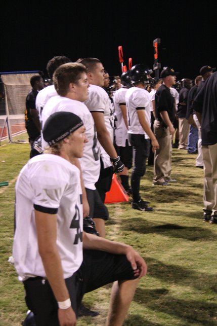 Members of Clark's football team watch from the sidelines as their defense falls to Coronado's offense.