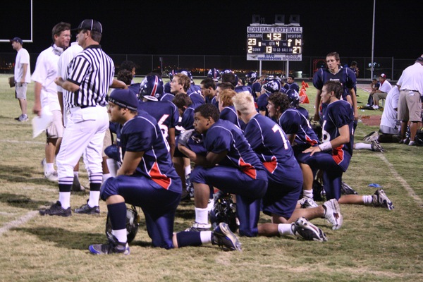 Members of the Coronado team look on after one of ...