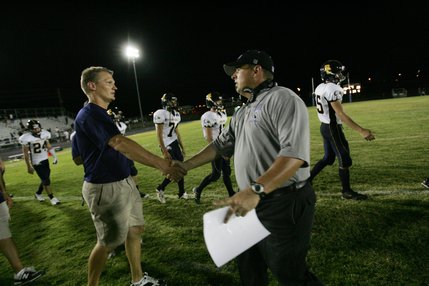 Boulder City football coach Alex Kazel, left, shakes hands with Basic head coach Jeff Cahill after losing the season-opener football game Friday.