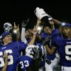 Members of the Basic High varsity football team celebrate after defeating Boulder City. 