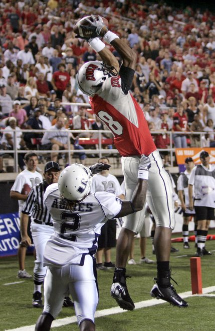 UNLV's Phillip Payne pulls down a pass in the end zone over Utah State defender Roy Hurst for UNLV's second touchdown Saturday at Sam Boyd Stadium.
