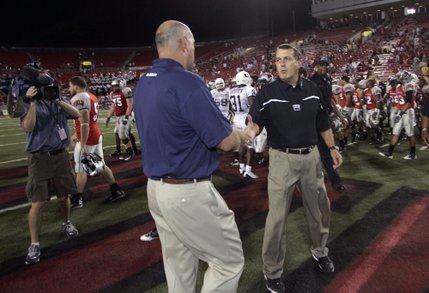 UNLV head coach Mike Sanford, right, shakes hands with Utah State head coach Brent Guy after UNLV's 27-17 victory at Sam Boyd Stadium.