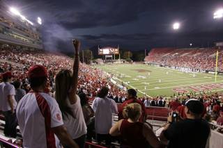 A UNLV fan celebrates Saturday as UNLV takes an early lead with a touchdown in the first quarter at Sam Boyd Stadium.