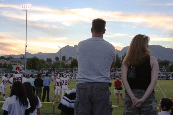Fans watch the Desert Oasis football team on Friday night ...