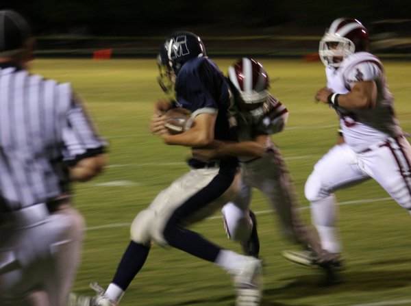 Quarterback Stott Brennen runs with the ball during the second ...