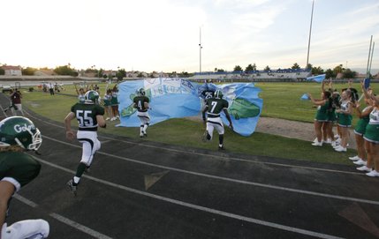Members of the Green Valley football team enter the field before the season opener against Bonanza High on Friday.
