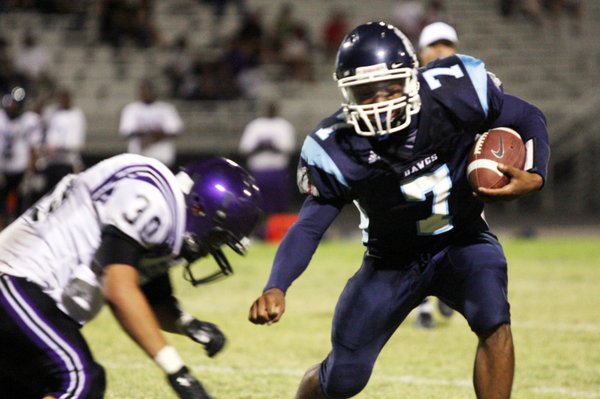 Centennial running back Brandon Wright, right, attempts to keep away ...