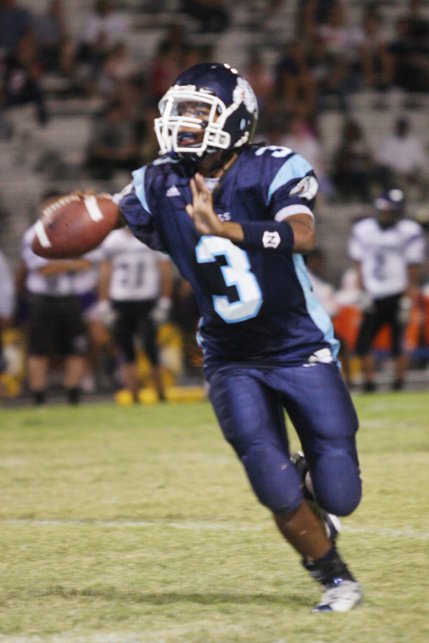 Centennial quarterback Chris Henderson looks for an open player before passing the ball.