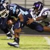Durango's Thomas Flanagan brings down Centennial's Chris Henderson during the football season opener at Centennial High School.