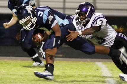 Durango's Thomas Flanagan brings down Centennial's Chris Henderson during the football season opener at Centennial High School.