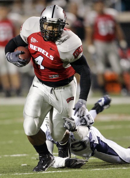 UNLV's Frank Summers gets taken down by Utah State's Caleb Taylor at Sam Boyd Stadium.