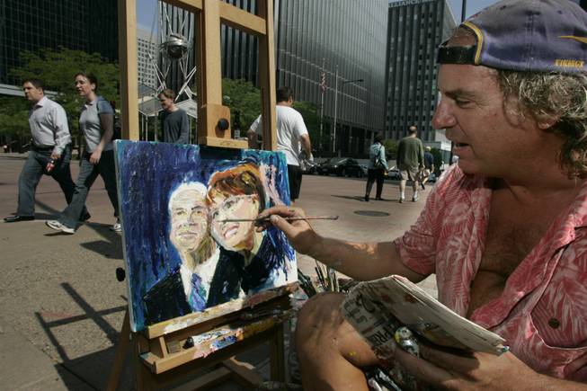 Patrick Ginter paints a portrait of the presumptive Republican nominee for president, John McCain, and his running mate, Sarah Palin, on Monday outside the Republican National Convention in St. Paul. "It's political season so you gotta paint political," Ginter said.