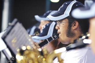 Cody Gerrarde of the Centennial Marching Band plays the clarinet during the football season opener at Centennial High School.