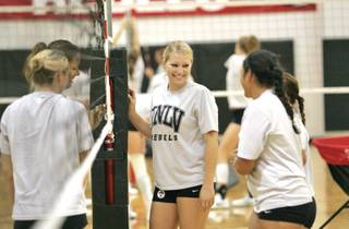 UNLV volleyball player Samantha Richard, center, talks with her teammates as they set up the volleyball net before practicing at the Cox Pavilion on August 27, 2008.