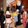 Maganda Antonio, 11, hugs Sherri Kohli, 15, dressed as an 8-foot character from a Japanese animated 